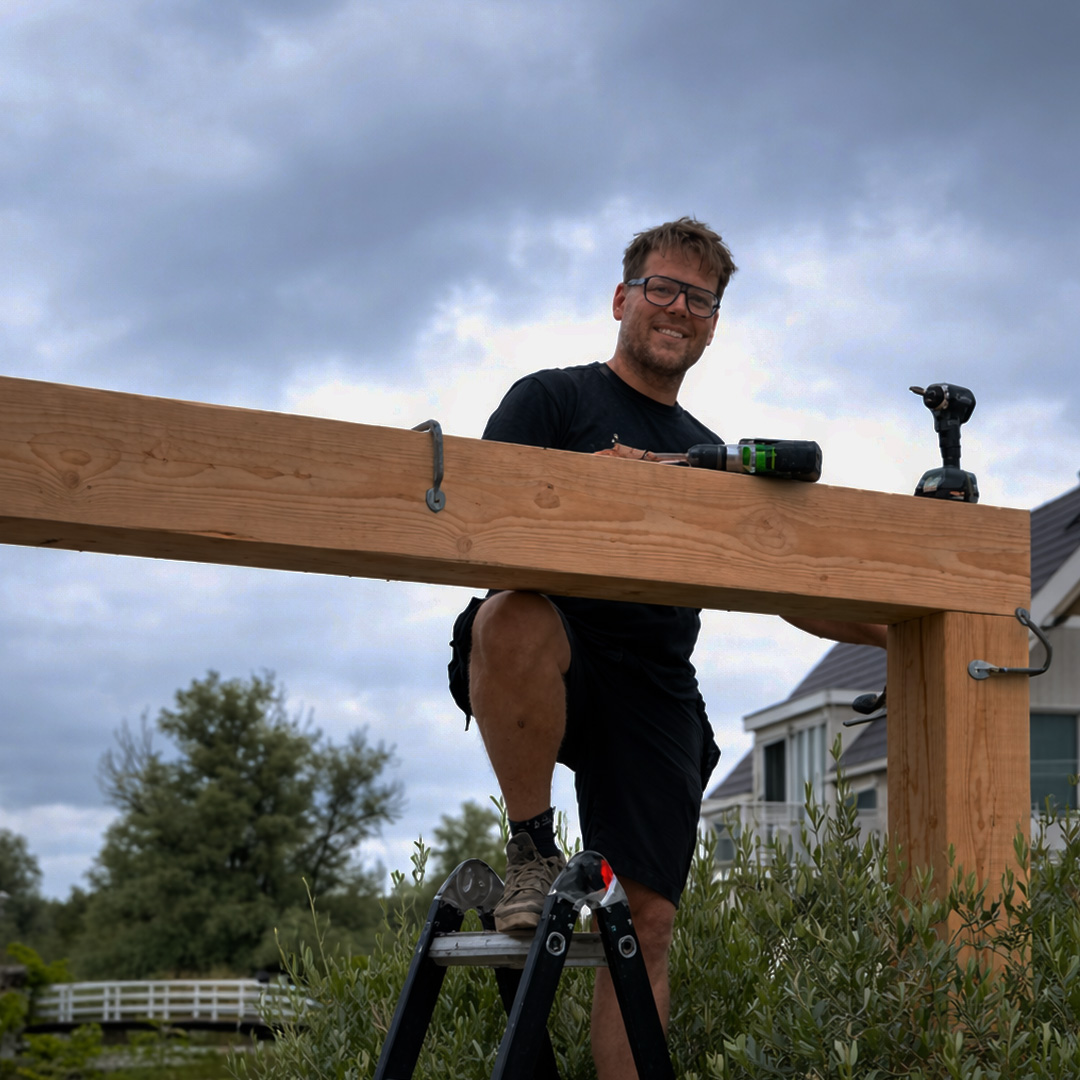 Edwin Hoeve working on wooden construction for Custom Outdoor Living