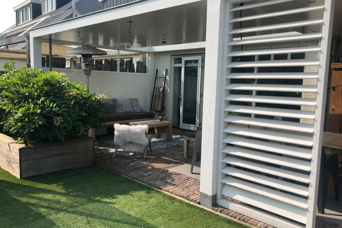 Modern outdoor living space project featuring covered patio with horizontal privacy screens and contemporary landscaping design