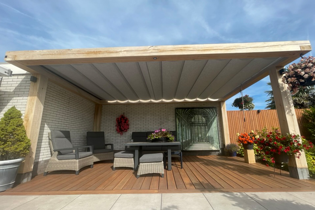 Covered wooden terrace project featuring integrated lighting, wooden decking, and outdoor furniture arrangement